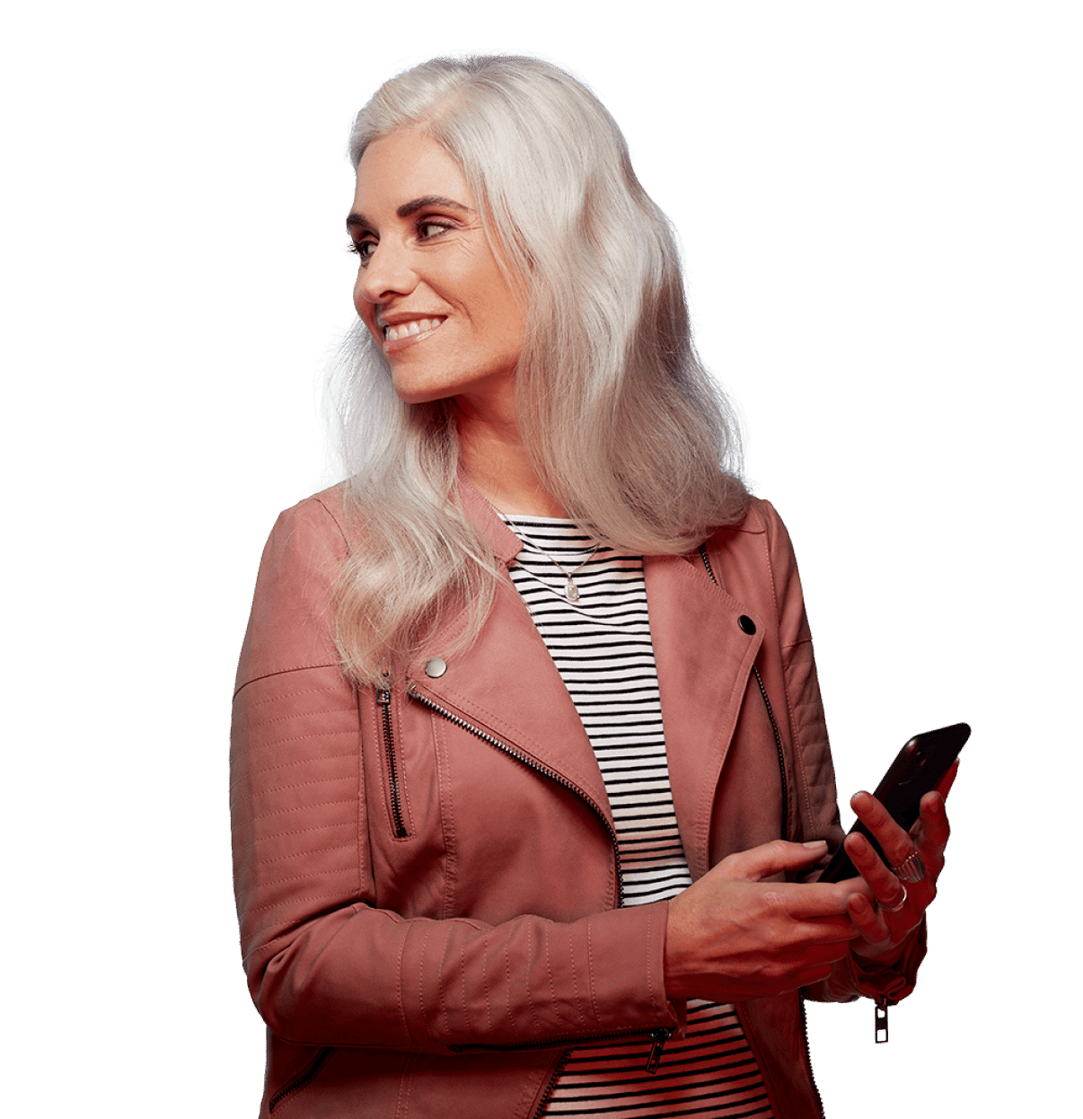 Older woman looking over her shoulder, smiling, holding a phone